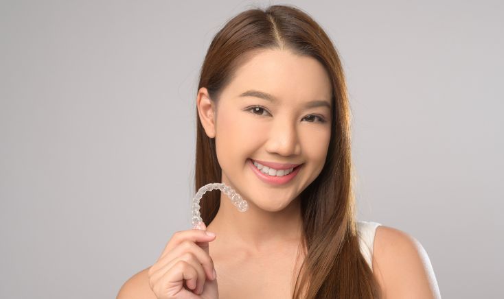 Patient wearing Invisalign clear aligners for teeth straightening