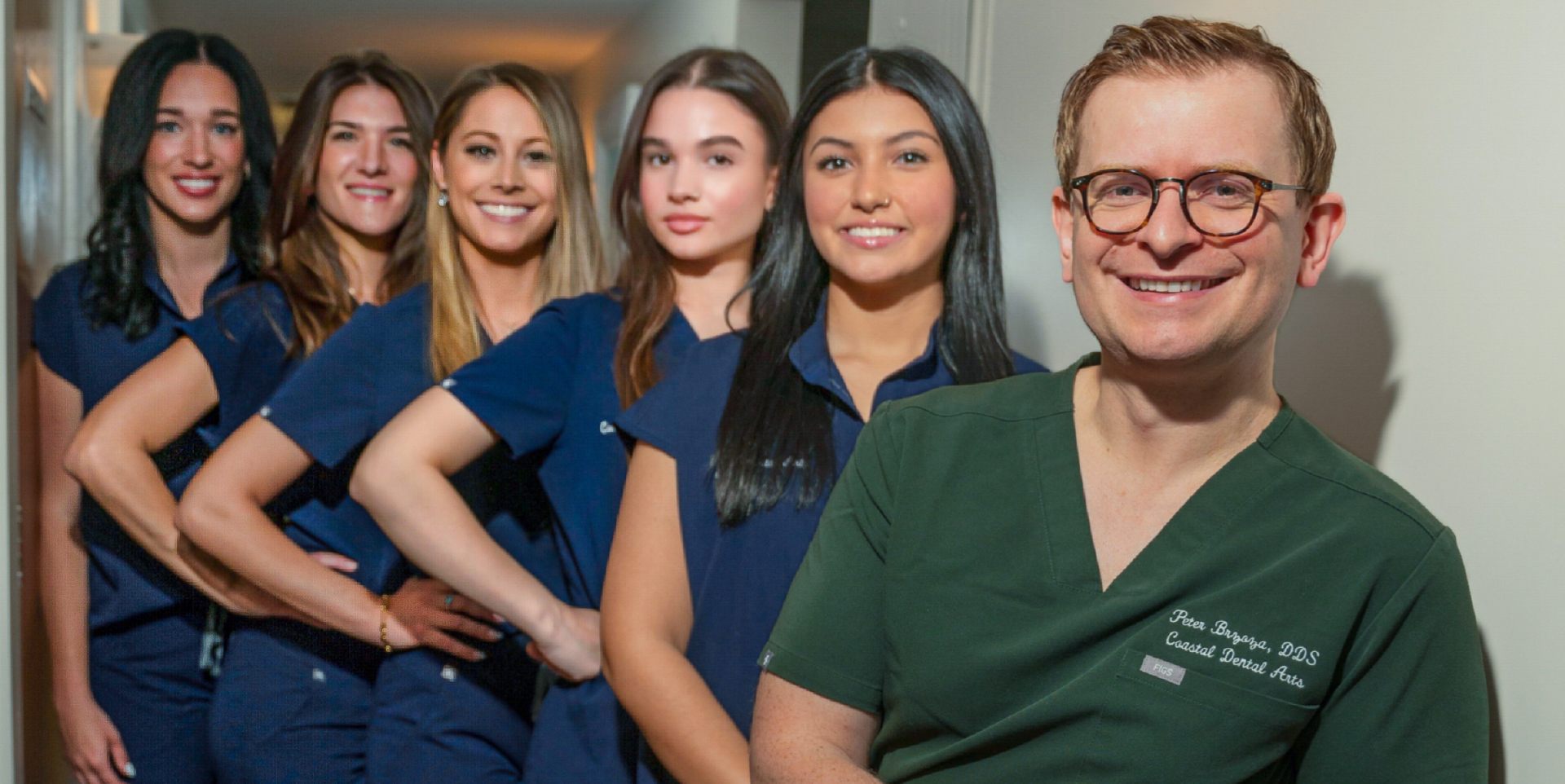 Dentist in peabody Dr. Peter Brzoza, DDS and dental staff group photo at coastal dental arts